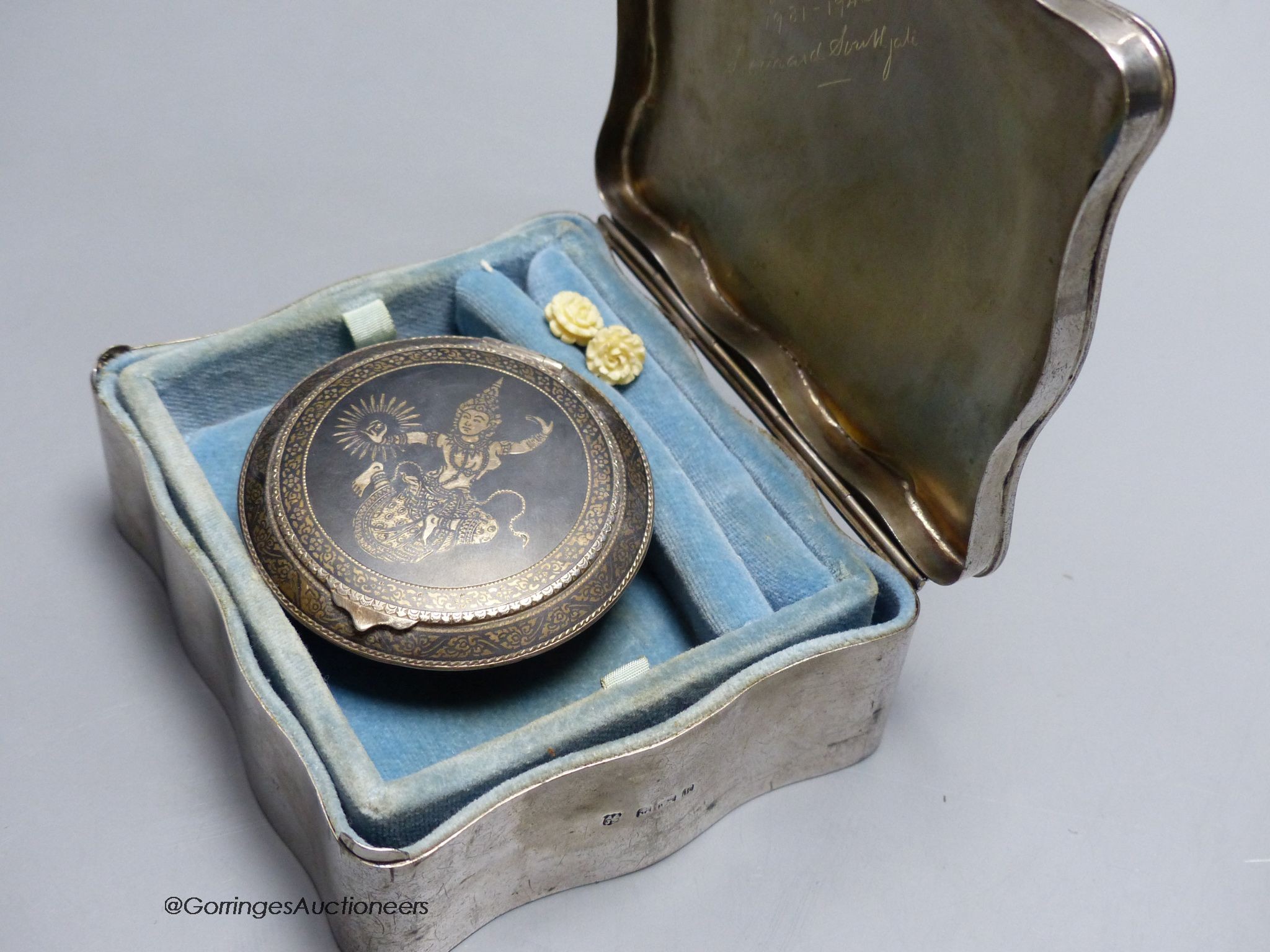 A Edwardian silver jewellery box, Birmingham 1909, 11.5 cm, engraved inscription inside, and a Thai white metal and niello work compact, 6.5cm